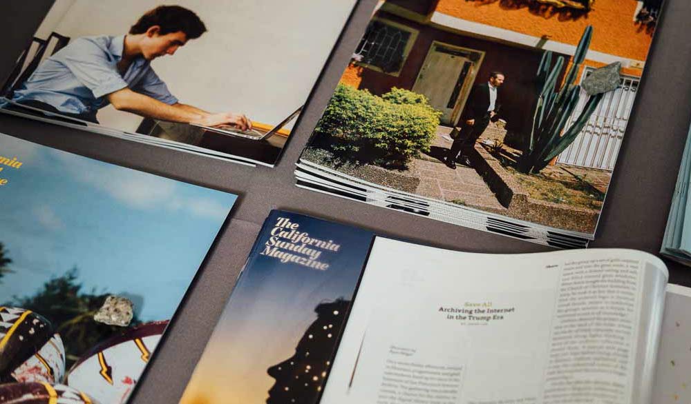 Stacks of magazines on a table at the San Francisco Art Book Fair