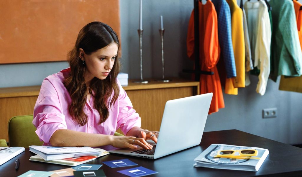 Person working on a book to sell on Amazon on laptop