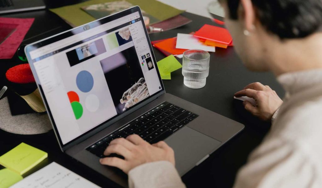 Person creating a custom notebook or journal on their computer.