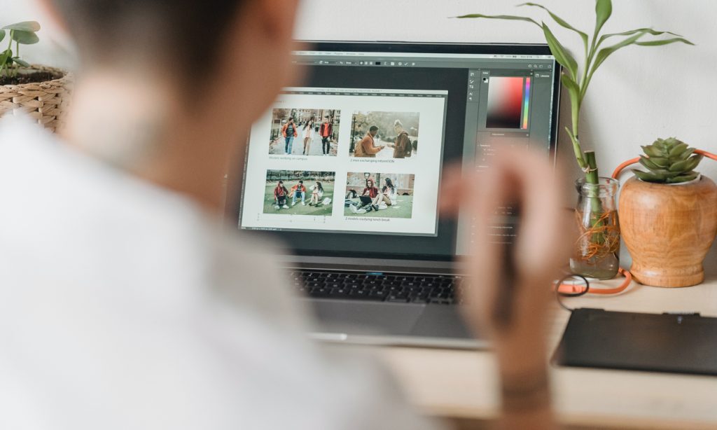 Photographer laying out their photography portfolio book on a laptop.