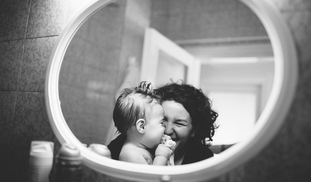 Black and white photo of mom and baby for a baby boo