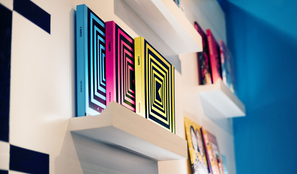 Layflat book, 4 Shapes by Alex Palacios, displayed on a shelf