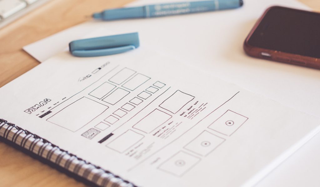 A sketch of a graphic design layout on paper.