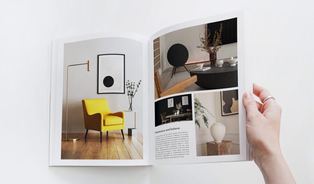 Printed interior design portfolio open to a two-page spread of designs and a small amount of text.