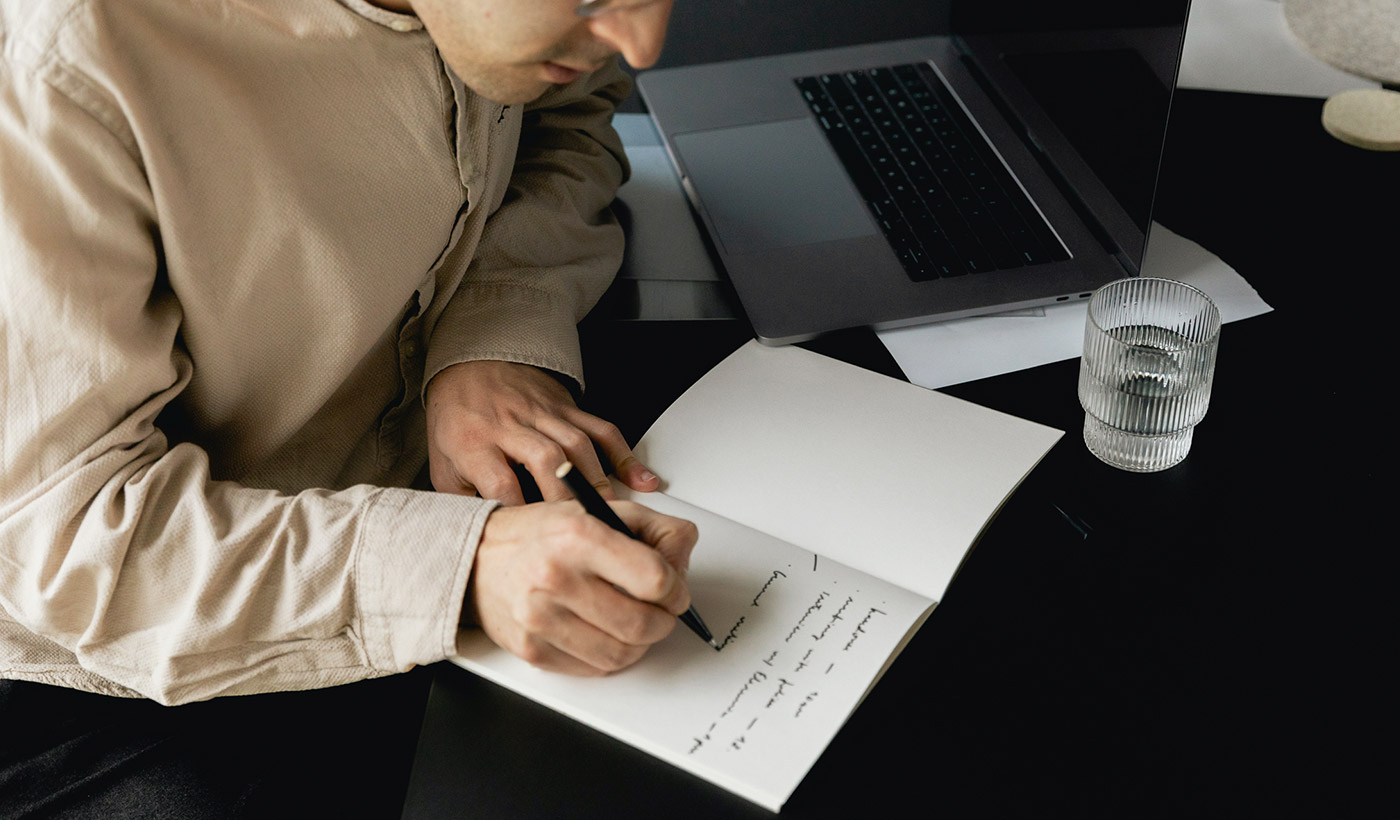 Person writing in a notebook.