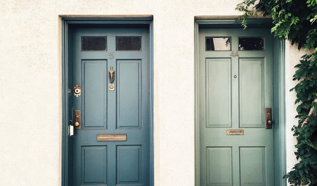 Two doors side by side, one blue, one green