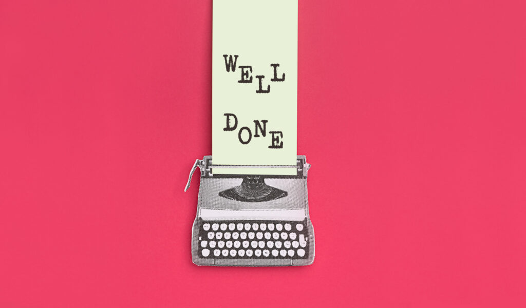 Colorful image of a typewriter typing out the message WELL DONE.