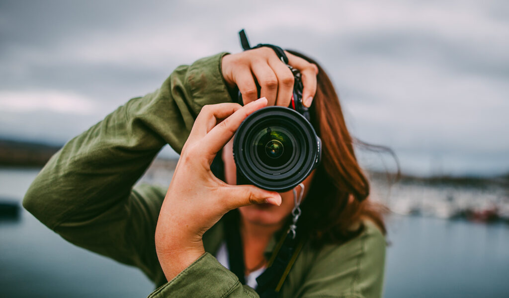 Female Photographer Using a DSLR Camera