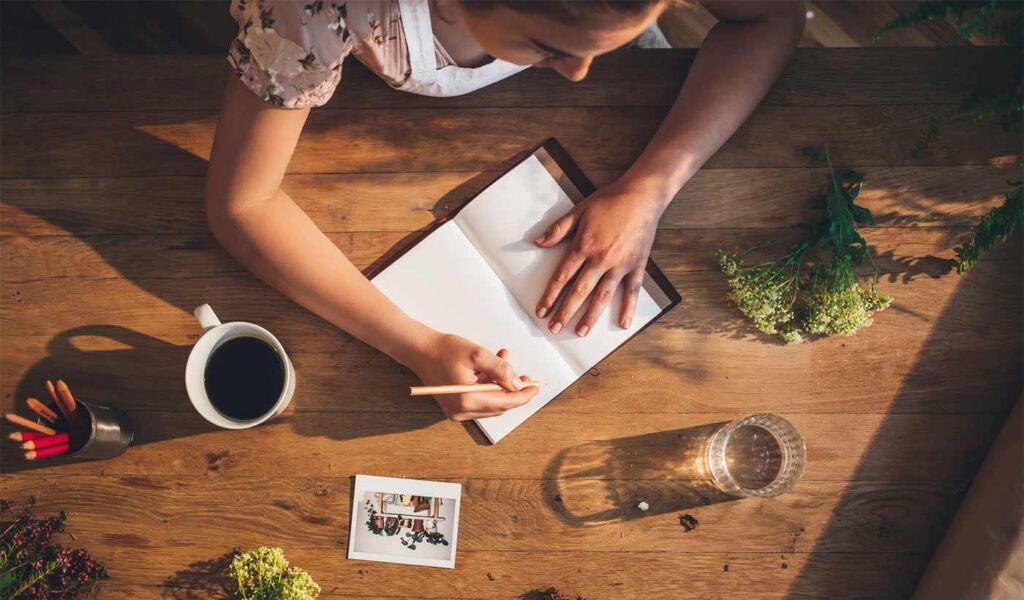 Woman writing in a gardening journal