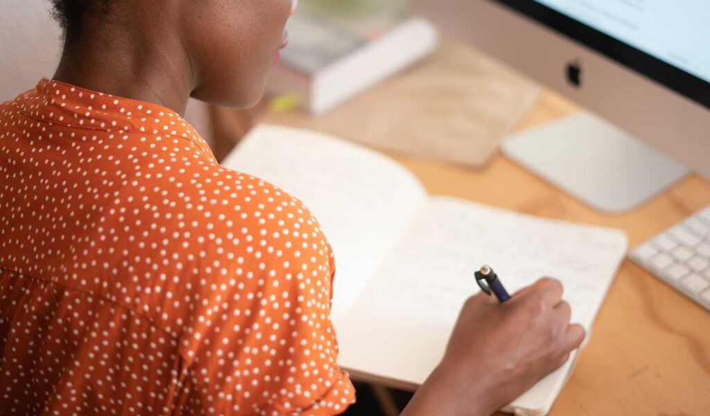 Femail self-publisher jotting down notes & ideas for her synopsis