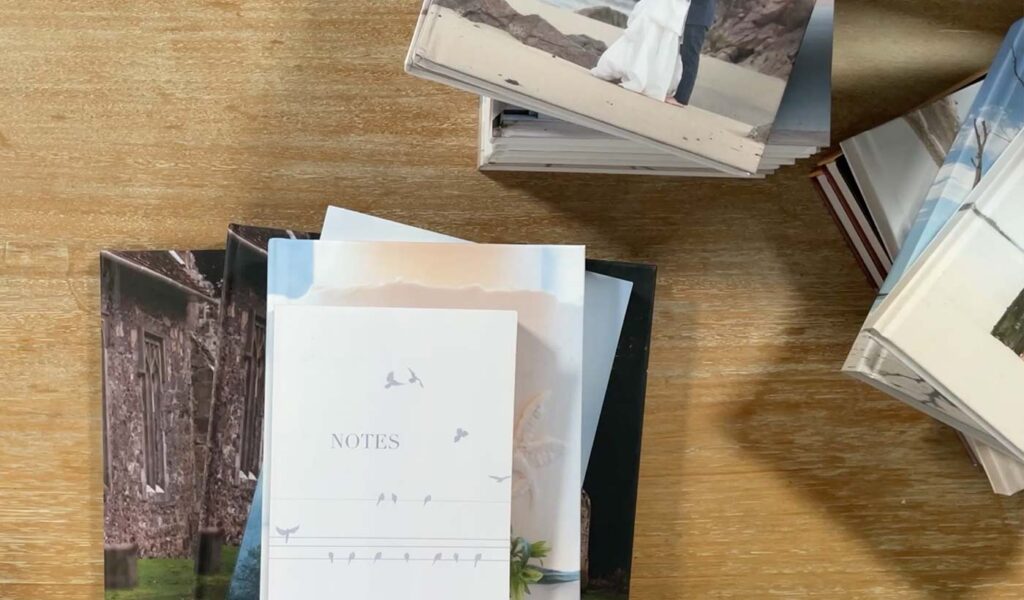 Stacks of photo books on wood desk