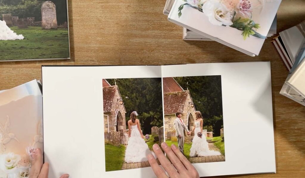 Open layflat photo wedding book on desk