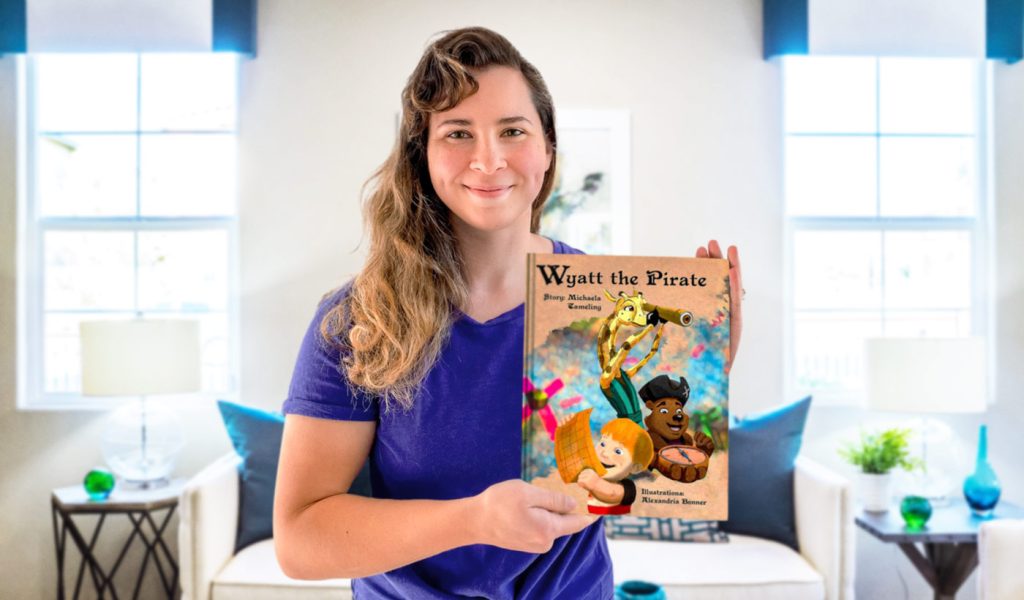 Self-published author Michaela Tameling holding up her book Wyatt the Pirate