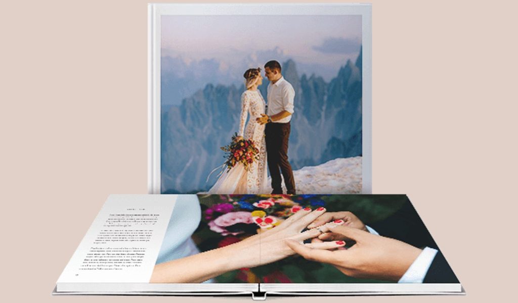 Two Blurb layflat wedding photo albums: one showing the bride and groom on the cover and the other showing the ring exchange