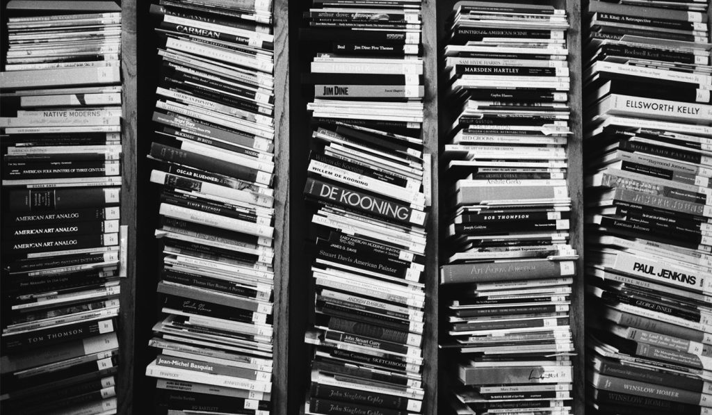 Black and white photograph of stacks and stacks of books