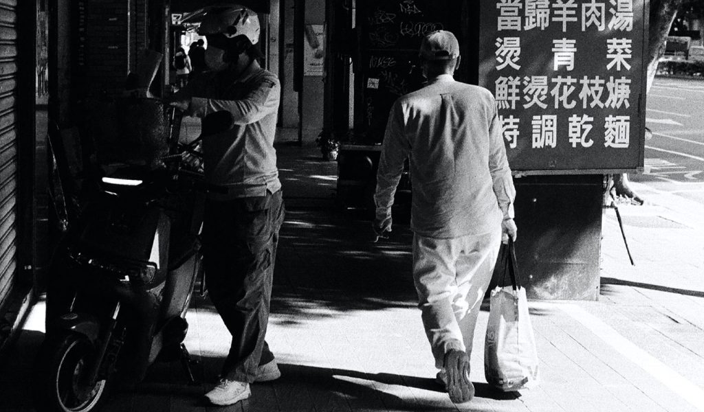 Black and white documentary photography with two people on a street