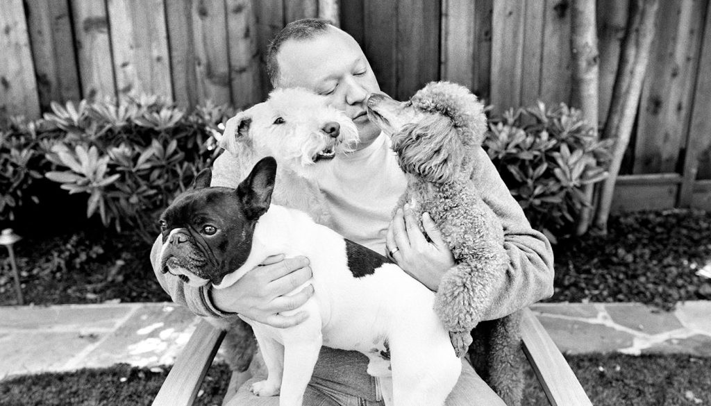 Jesse Freidin's photograph of three dogs in the arms of their owner