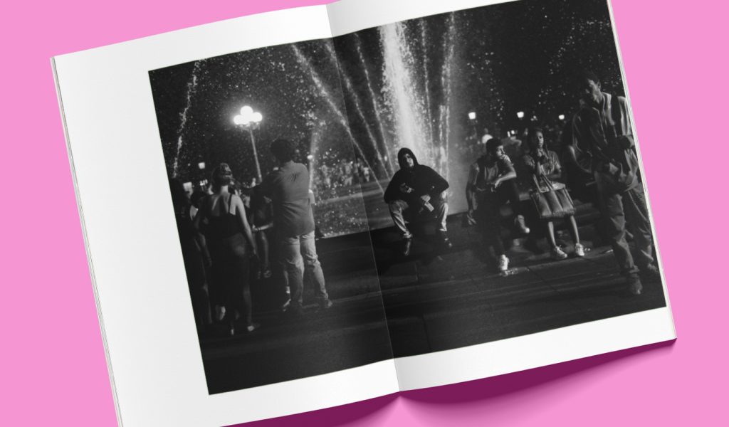 Street photography book open on to a picture of people and a fountain.