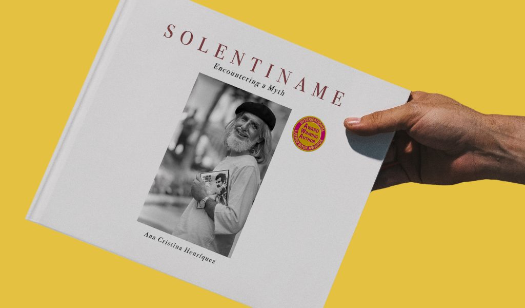 Solentiname book held on a yellow background.