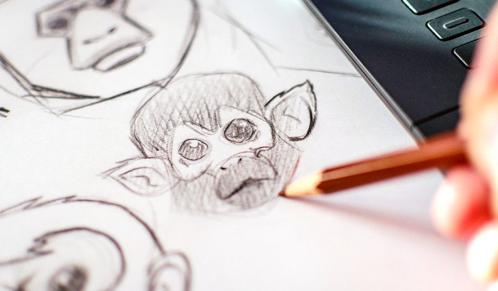 Children's book illustrator sketching a monkey face.