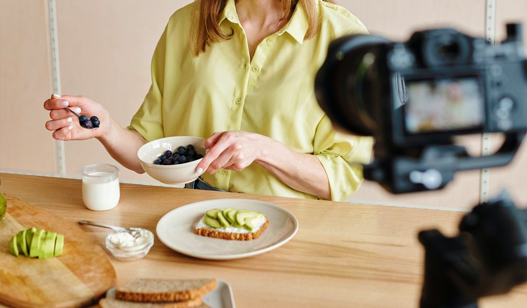 Person photographing a food scene, making a coffee table book