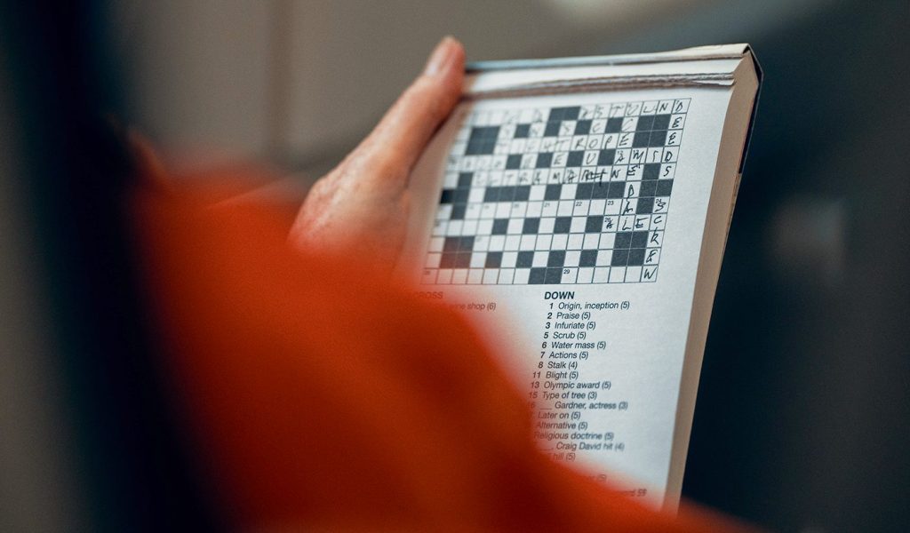 Person holding a crossword puzzle