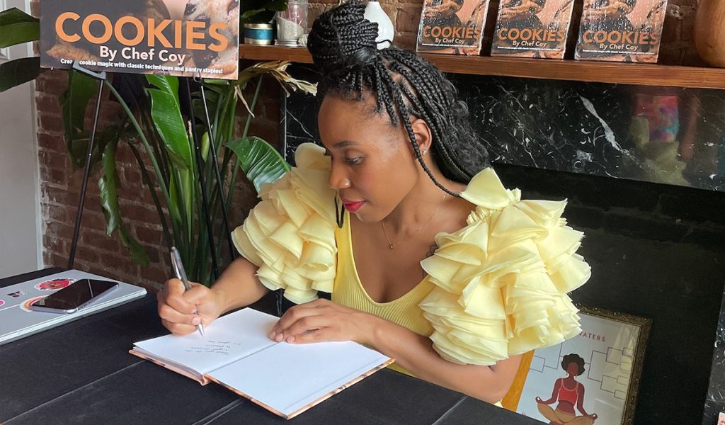 Secoyah Browne signing self published cookbook Cookies by Chef Coy
