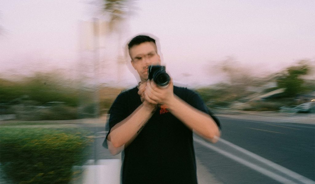 Person holding a camera with a blur