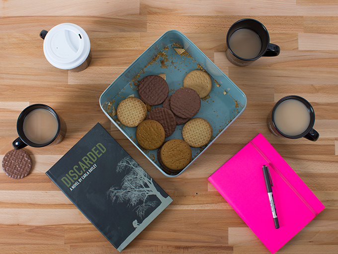 Coffee cups, books, and notebooks on a table